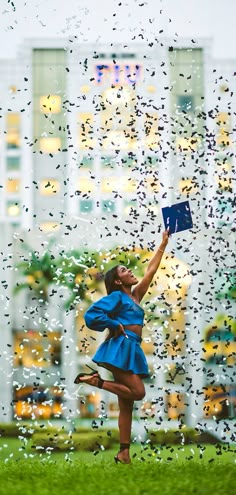 a woman in a blue dress is flying through the air with her arms up and legs spread out