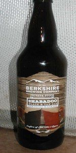 a bottle of beer sitting on top of a wooden table