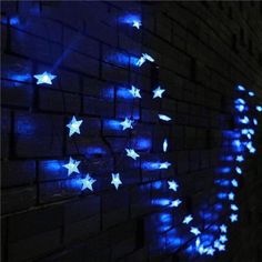 a brick wall with stars on it and blue light coming from the top to the bottom