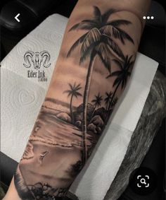 a man's arm with a palm tree and beach scene tattoo on the forearm