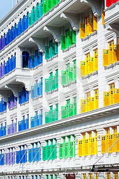 a multicolored building with many windows and balconies