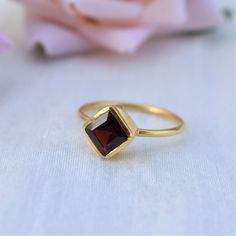 D E T A I L S - Stone: Natural Garnet Stone Shape: Cushion - Square Material: Sterling silver The fit: True to US ring size Finish: Smooth and Gold Plated to a high shine S H I P P I N G & P R O D U C T I O N - My current production time is 2-6 business days, which means after those days are up, your order ships! I make everything custom to order, by hand, but I promise you it's worth the wait! R U S H - M Y - O R D E R - If you're in a rush to get your pretty new pieces, please send me a me Formal Stackable Open Rings With Birthstones, Formal Birthstone Stackable Open Rings, Classic Amethyst Ring For Gift, Elegant Stackable Garnet Gemstone Rings, Elegant Garnet Gemstone Stackable Rings, Garnet Round Cut Rings As Gift, Garnet Round Cut Rings For Gift, Classic Gemstone Birthstone Ring As Gift, Garnet Solitaire Ring As Gift