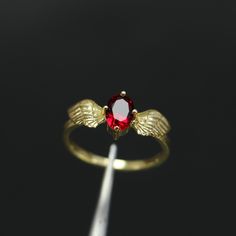 Bohemian Gold Plated Angel Wings Ring, Ruby Ring, Ethnic Ruby Ring, Boho Style Angel Wings Ring, Stunning Gold Retro Angel Wing -->Ring details: - Theme:Romantic Wedding & Engagement - comfortable band - Center Stone : Ruby - Ruby carat: 5*7mm --->Materials:   - 925 Silver Gold Plated - 14k rose gold --->The ring size on the model is 4 US. --->Items are shown larger in pictures to show detail - please note the dimensions. This item is in my shop are handcrafted made to order. --->Accessories: - Angel Wings Ring, Wings Ring, Wing Ring, Rubin Ring, Angel Wing Ring, Ruby Ring Gold, Ring Ruby, Pandora Rings, Gold Engraving