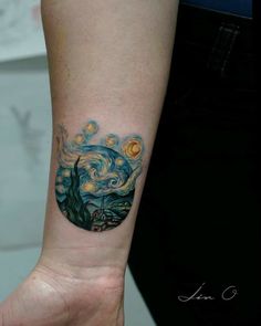 a person's arm with a tattoo on it that looks like the starry night