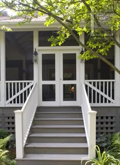 a porch with steps leading up to the front door