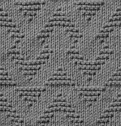 a gray knitted blanket with wavy lines