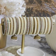 This stylish bangle set is crafted with love and care by the finest artisans, and is the perfect accessory for your destination Indian wedding. Its white colour complements any colour palette, bringing a unique and chic flair to your nuptials. Make your special day even more memorable with this handcrafted bangle set. Indian Bridal Bangles, Indian Bangles Set, Indian Bangles, Bangles Set, Bangles Indian, Bridal Bangles, Color Complement, Kundan Jewellery, Bangle Set