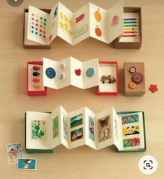 an open book with pictures and magnets in it on top of a wooden table