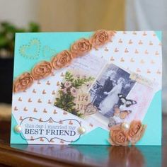 a card with flowers on it sitting on top of a table