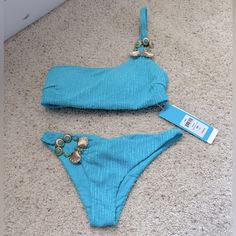 Brand New Beach Bunny Bikini. Embellished One Shoulder Top Size Small. Embellished Skimpy Bottom Size Extra Small. Hygiene Liner Missing As It Peeled Off When I Remove The Tissue Protecting The Embellishment. Beautiful Blue Color, Perfect For Your Next Vegas Pool Party Or Vacation. Embellished Swimwear For Summer Beachwear, Embellished Swimwear For Summer, Embellished Beachwear Swimwear For Summer, Embellished Swimwear For Summer Pool, Embellished Swimwear For Summer Pool Season, Embellished Swimwear For Pool And Summer, Embellished Swimwear For Pool And Beach Season, Embellished Beachwear Swimwear For Party, Embellished Fitted Swimwear For Summer