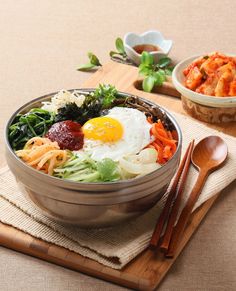 a bowl of food with chopsticks on the side