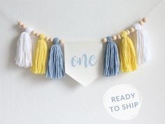 a banner with tassels hanging from it's sides that says one ready to ship