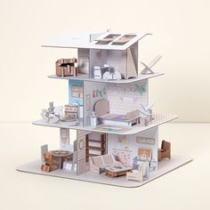 a paper model of a house with lots of furniture and accessories on top of it