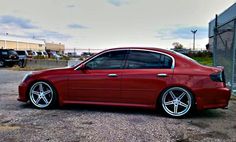 a red car parked in front of a building