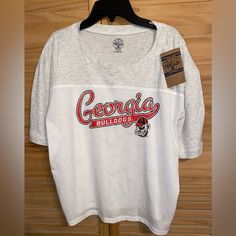 Georgia Tech Ladies Tee Shirt - Half Cotton /Half Jersey Material O Size Large O Armpit To Armpit: 22.5 In. O Shoulder To Hem: 22 In. O Material: Cotton / Polyester (See Photo For Specifics) O Short Sleeve O Color: Gray White Red Black O New With Tags Ladies Tee Shirts, Georgia Bulldogs, Georgia Tech, Jersey Fabric, Gray White, Womens Tees, Black Gray, Tee Shirt, Georgia