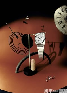 a watch and other items on display in front of a red background with chinese characters