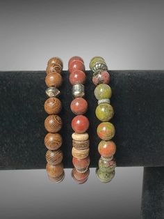 dd a touch of bohemian elegance to your jewelry collection with this stunning Unakite and Mixed Bead Bracelet Stack from Ethereal Elements. This set includes three 7-inch bracelets, each uniquely designed to complement one another while showcasing a beautiful blend of earthy tones and natural materials. The focal point of the stack is the Unakite beads, known for their harmonious blend of green and pink hues, symbolizing balance and emotional healing. Complementing the Unakite, the mixed beads i Bohemian Beaded Bangle Bracelets With Natural Stones, Bohemian Jasper Beaded Bracelets With Natural Stones, Rustic Adjustable Bracelets With Round Beads, Bohemian Jasper Bracelets With Gemstone Beads, Spiritual Jasper Beaded Bracelets With Natural Stones, Spiritual Jasper Beaded Bracelets As Gift, Bohemian Stackable Bracelets With Round Beads, Bohemian Stackable Round Bead Bracelets, Bohemian Stackable Crystal Bracelet As Gift