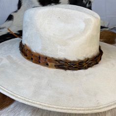 Natural feather hat band. Adjustable with a leather tie. Natural colored feathers Adjustable hatband Approx. 1 inch wide *This product is for 1 single hat band. Hat not included. Feather Hat Band, Colored Feathers, Kimes Ranch, Coloured Feathers, Leather Tie, Hat Accessories, Feather Hat, Western Hats, Hat Band