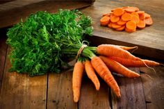 carrots and parsley on a wooden table