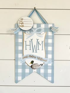 a blue and white sign with a bird on it that says hwm thank mom williams