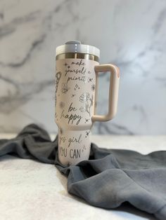 a travel mug sitting on top of a table