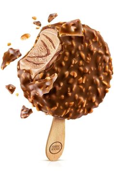 an ice cream scoop with chocolate sprinkles and nuts on it, in front of a white background