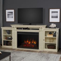 a living room with a fireplace and entertainment center