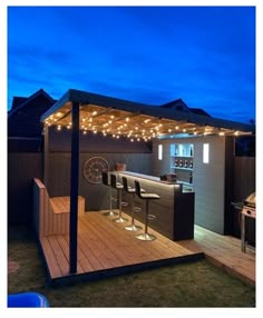 an outdoor bar with lights on the roof and barstools in the back yard