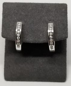 Vintage 14K White Gold with an Est. .25 TCW Diamond Earrings. Marked 14K inside earrings. Weighs 2.6 dwt. We do not check prongs for wear or stones for looseness. All items are sold AS IS, noting that we are a resale shop so everything here had a previous owner! We will include flaws in the description when noted. This is one of the reasons our items are more affordable than new at a jewelry store. Are these stones real or fake? Aside from diamonds, we do not know if any gemstones are natural or synthetic. We will state on certain gemstones, that we know 100%, if they are created or fake due to their lack of inclusions. For this reason, we do not sell any diamonds without inclusions, and the larger diamonds (half ct+) are soft graded. In recent years, synthetic gemstones are being created Classic Hallmarked Diamond Earrings For Formal Occasions, Classic Hallmarked Diamond Earrings For Formal Events, Classic Huggie Jewelry For Formal Occasions, Classic Formal Huggie Jewelry, Diamond White Gold Clip-on Earrings For Anniversary, Timeless Brilliant Cut Huggie Earrings For Formal Events, Timeless Brilliant Cut Huggie Earrings For Formal Occasions, Classic Round Cut Huggie Earrings For Formal Occasions, Classic Round Cut Huggie Earrings For Formal