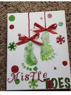 a handprinted christmas card with red ribbon