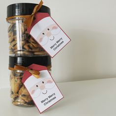 two glass jars filled with cookies sitting on top of a table