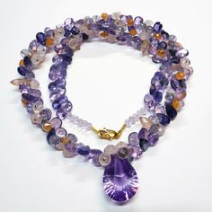 "DESCRIPTION: Thank you for coming in! A breath-takingly beautiful necklace made of an assortment of natural gemstones! You can find Iolite, Amethyst, sunstone and peach moonstone in this one necklace! Premium quality gemstones finished with gold filled headpins and 18k solid yellow gold clasp! 17\" gorgeous necklace, 186.9 carats! You'll get the necklace you see! SIZE: 14.7mmx23.5mm center stone. GRADE: Transparent COLOR: Multi" Multi-stone Amethyst For Jewelry Making, Luxury Amethyst Multi-stone Necklace, Luxury Multi-stone Amethyst Necklace, Amethyst Multi-stone Briolette Gemstones, Amethyst Briolette Multi-stone Gemstones, Luxury Amethyst Gemstones With Natural Stones, Luxury Natural Amethyst Gemstones, Briolette Amethyst Natural Stone Gemstones, Teardrop Amethyst Necklaces With Gemstone Accents