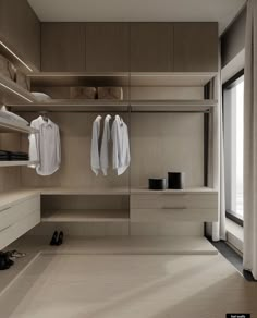 an empty walk - in closet with clothes and shoes