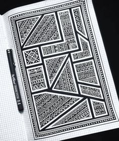 a notebook with some black and white designs on it