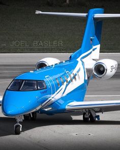 a blue and white airplane is on the runway with its wheels down, ready to take off