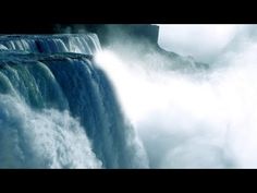 a large waterfall with water pouring out of it's sides and into the air