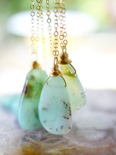 This stunning necklace is handmade with gorgeous specimens of natural Chrysoprase. This gem, also known as green Chalcedony, is said to promote joy and happiness, as well as attract love and prosperity. No two pendants are the same. Some are minty green, while others have flecks of brown, white, or black within them. The chains are sterling silver or 14k gold filled. So go ahead, flaunt your unique style! GEMSTONE: Chrysoprase STONE SIZE: 20 to 32mm (.78 to 1.25") STONE SHAPE: Irregular Smooth P Handmade Chrysoprase Necklaces In Nature Style, Unique Green Necklace With Natural Inclusions, Green Prehnite Necklace For Gift, Green Chrysoprase Necklace For Healing, Handmade Green Chalcedony Necklaces, Nature-inspired Chrysoprase Necklaces, Nature-inspired Chrysoprase Necklaces As Gift, Nature-inspired Chrysoprase Necklace As Gift, Necklaces Summer