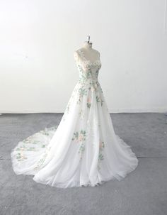 a white wedding dress with flowers on it