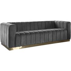 a gray couch with gold legs and a black back rest on an isolated white background