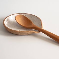 two wooden spoons sitting next to each other