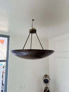 a large metal bowl hanging from the ceiling