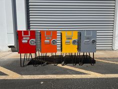 four metal lockers sitting in front of a garage door on top of each other