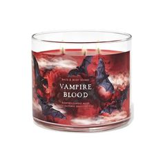 a candle that is sitting in front of a red background with vampire blood on it