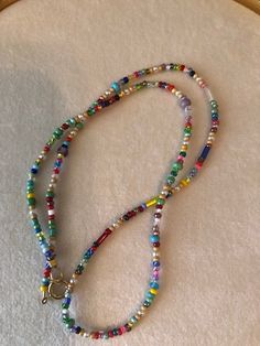 a beaded necklace with a cross on it