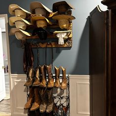 a rack with hats and boots hanging from it's sides next to a door