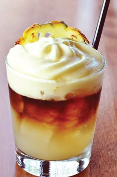 an iced drink with whipped cream and pineapple on top