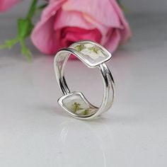 Resin ring meticulously crafted using real flowers and fully cured UV resin. The flowers silver ring is inspired by the graceful charm of Boho jewelry. This white silver band  is a perfect meaningful gift for a beloved woman, and as a pampering gift for yourself. The jewelry is very flattering, lightweight, comfortable to wear as jewelry for everyday use and impressive as jewelry for a special occasion. Each piece is individually crafted to order, ensuring a unique touch, with subtle variations that make every piece truly one-of-a-kind. Elevate your style with this exceptional jewelry- a wearable piece of art designed for your enjoyment. Purchase now for an exquisite blend of nature and craftsmanship. Special Features: - Handmade with real flowers, fully cured UV resin  - Flowers colors : Handmade White Gold Flower Jewelry, Handmade Adjustable Flower Ring For Anniversary, Nature-inspired Open Flower Ring Gift, Unique Sterling Silver Flower Ring For Wedding, Handmade Dainty Open Flower Ring, Handmade White Gold Open Band Jewelry, Unique Open Flower Ring For Anniversary, Handmade White Sterling Silver Rings, Handmade Open Band Rings For Wedding