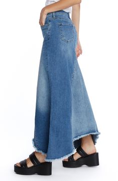 This updated jean skirt is designed in a pieced longline silhouette with a feathery fringed hem. 30" to 37" center front length (size 29) Unlined 91% cotton, 7% polyester, 2% spandex Machine wash, tumble dry Imported Spring Wide Leg Denim Skirt With Frayed Hem, Spring Denim Skirt With Unfinished Hem, Spring Denim Skirt In Dark Wash With Unfinished Hem, Spring Dark Wash Denim Skirt With Unfinished Hem, Spring Dark Wash Bottoms With Unfinished Hem, Wide Leg Denim Skirt With Frayed Hem, Chic Denim Skirt With Frayed Hem For Fall, Cotton Skirt With Unfinished Hem, Chic Fall Denim Skirt With Frayed Hem