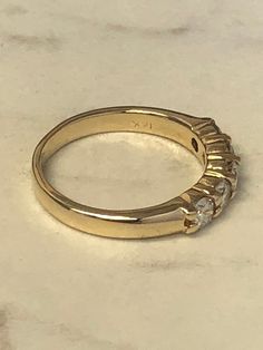 A beautiful Classic 14kt Yellow Gold Lady's Diamond Wedding/Anniversary/Stackable Band consisting of 5- full cut round brilliant diamonds .90ct total weight. All diamonds are SI1 clarity, G color and shared prong set in 4mm wide mounting in finger size 7 3/4. This style band would make a GREAT stackable band also. This item would Retail for $ 6,770.00 Diamond Wedding Anniversary, Stackable Bands, Brilliant Diamond, Mens Wedding Bands, Gold Hoop, Wedding Men, Gold Hoop Earrings, Diamond Wedding, Round Brilliant