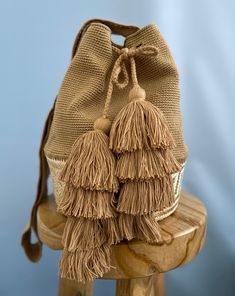 Handmade bag in brown and natural colors. Handmade by Colombian artisans. Eco-friendly Beige Crochet Bucket Bag, Brown Crochet Bucket Bag For Vacation, Bohemian Brown Bucket Bag With Double Handle, Bohemian Pouch Bucket Bag With Leather Handles, Chic Handmade Beige Bucket Bag, Beige Jute Bucket Bag With Adjustable Strap, Bohemian Natural Bucket Shoulder Bag, Chic Beige Handmade Bucket Bag, Everyday Brown Woven Bag